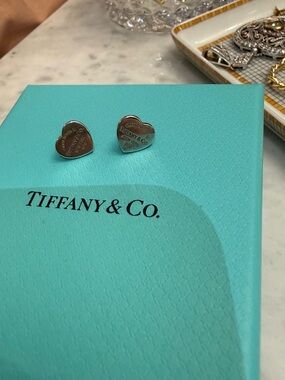 Tiffany & Co. Silver Heart Stud Earrings on Signature Blue